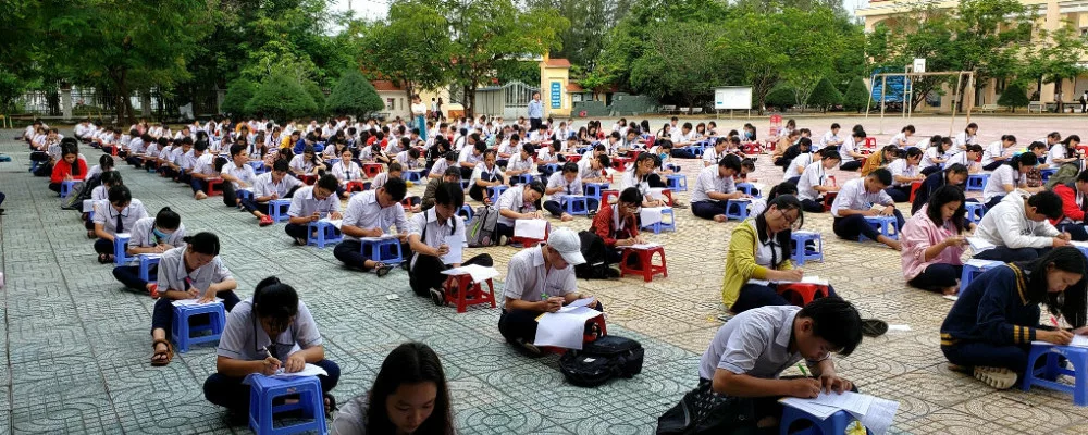 Vietnamese students sitting on ground